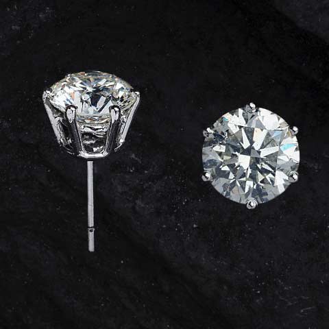 Diamon studs set on a post with black background